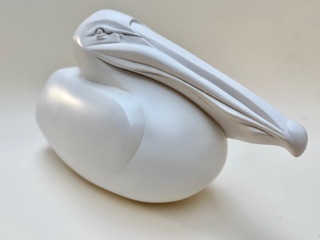 Pelican Sculpture blanche stylisée d'un oiseau avec un long bec courbé.